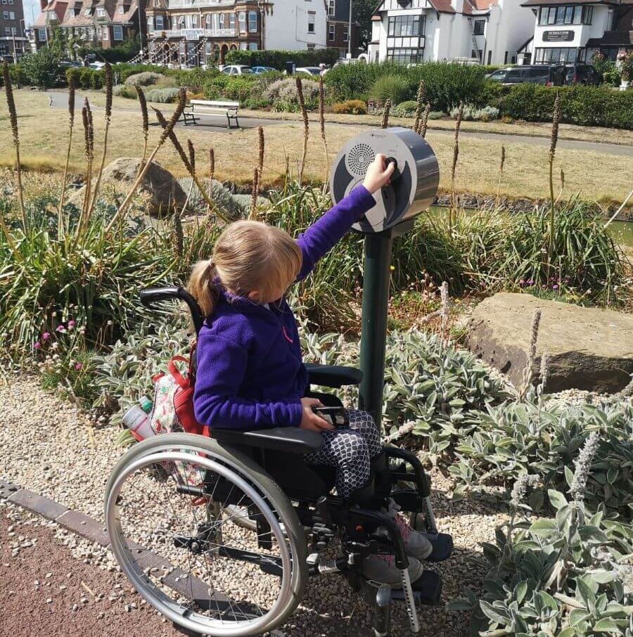 A young wheelchair user on a sensory pathway.