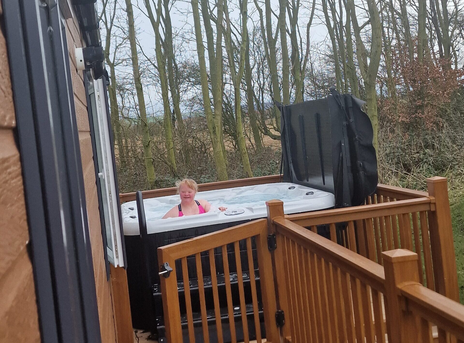 A young lady enjoying a hot tub whilst on holiday.