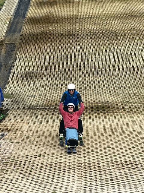 A group holiday guest enjoying a day dry slope skiing.