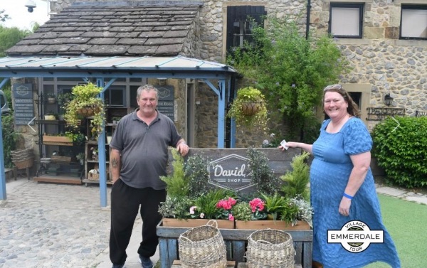 A man and woman smiling at the camera. The photo is taken where Emmerdale is filmed.