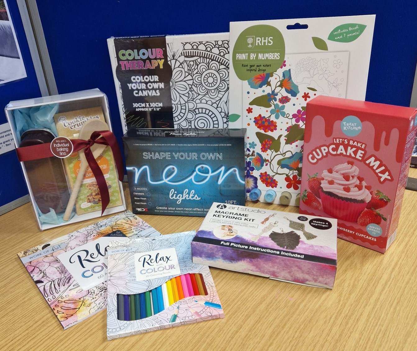 A selection of painting, making and baking activities arranged in front of a blue background. 